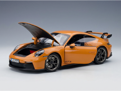 Orange Porsche GT3 scale model car with open hood, showcased by Vroomi for collectors.