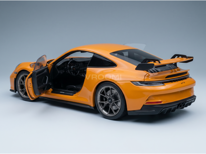 Orange scale model car with open door, detailed interior, at Vroomi