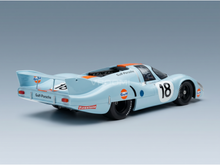 Gulf-Porsche 18 scale model car in light blue with orange accents, showcased by Vroomi for collectors.