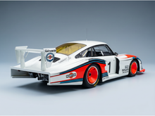 Martini-liveried Porsche 935 scale model car with Shell decals, showcased by Vroomi for collectors.