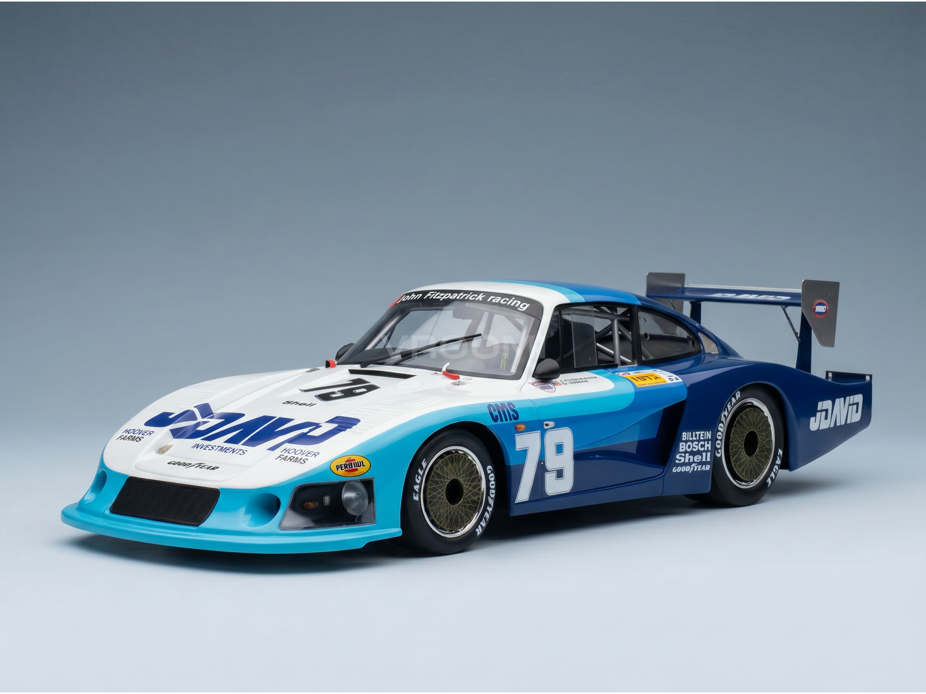 Coche en miniatura azul y blanco con adhesivos de competición, número 79, de Vroomi