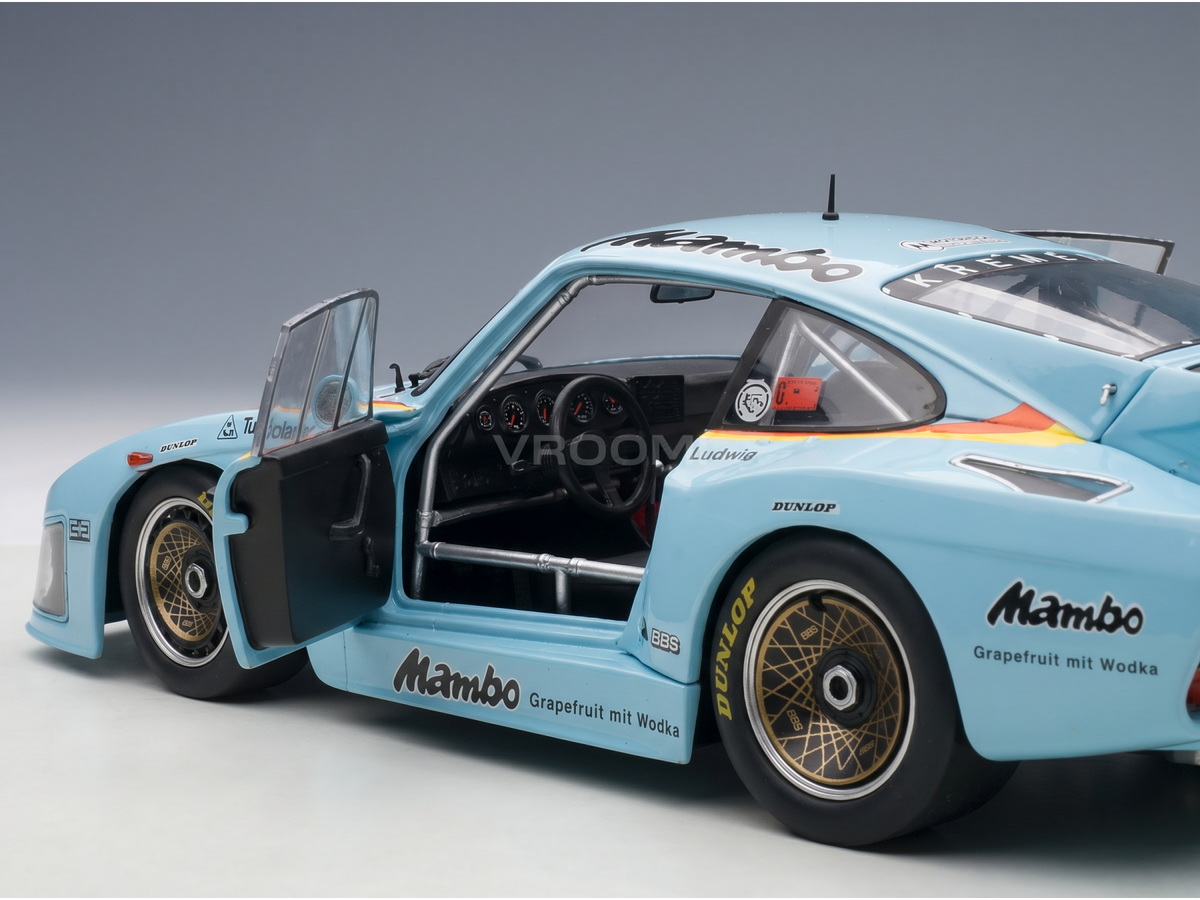 Light blue Mambo racing scale model car with open door, Dunlop tires, and Vroomi branding
