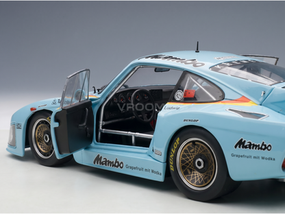 Light blue Mambo racing scale model car with open door, Dunlop tires, and Vroomi branding