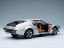 Silver scale model car with open door, showcasing tan interior and A310 badging, from Vroomi