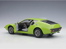 Vroomi scale model car: vibrant green 1/18 replica with open doors, detailed interior, and classic design.
