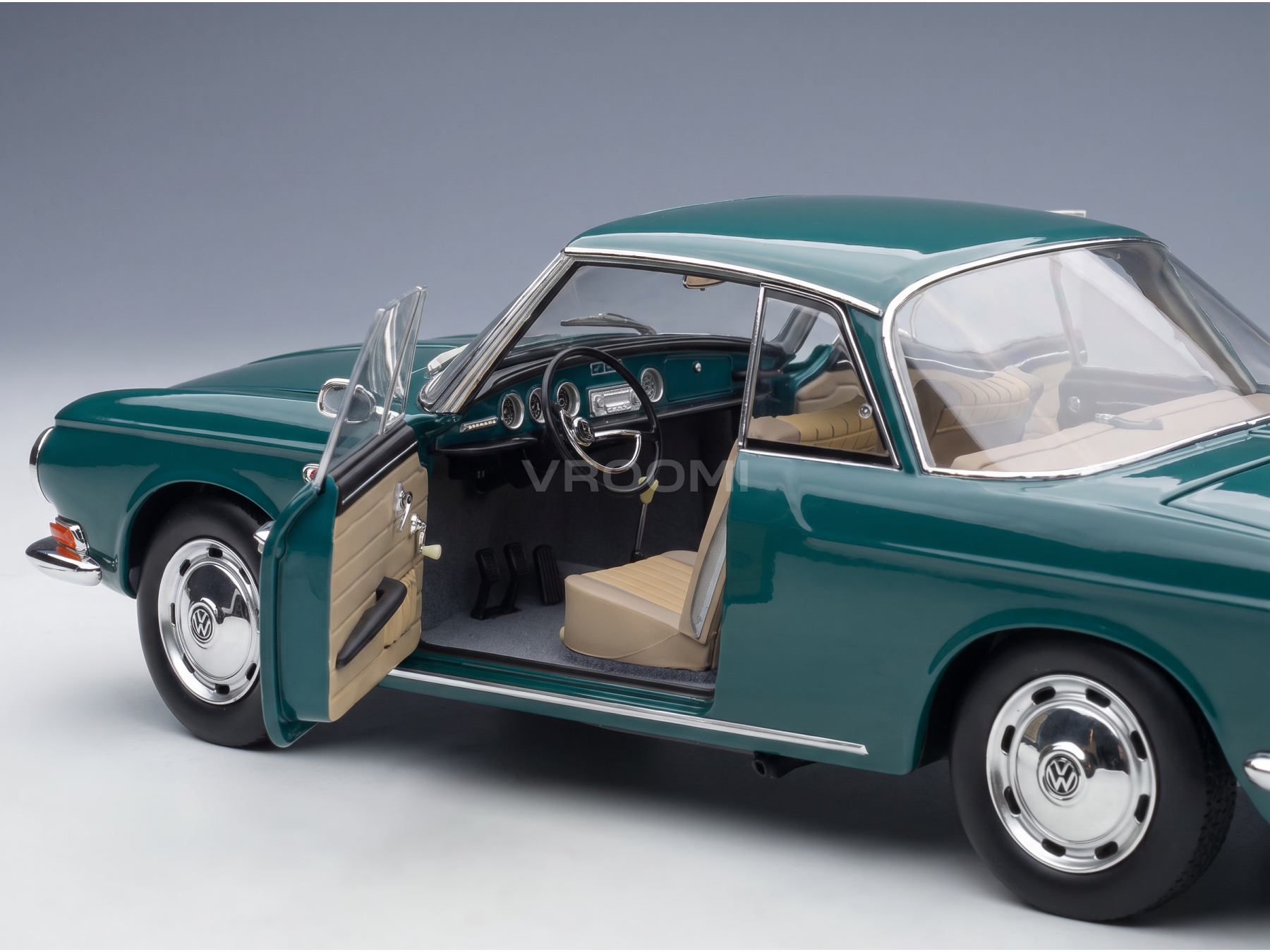 Teal Volkswagen scale model car with open door, tan interior, detailed dashboard — Vroomi