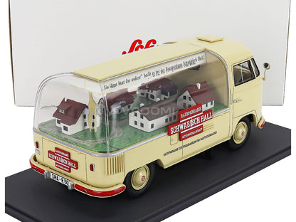 Cream VW bus scale model car with miniature houses inside, displayed on black base. Vroomi