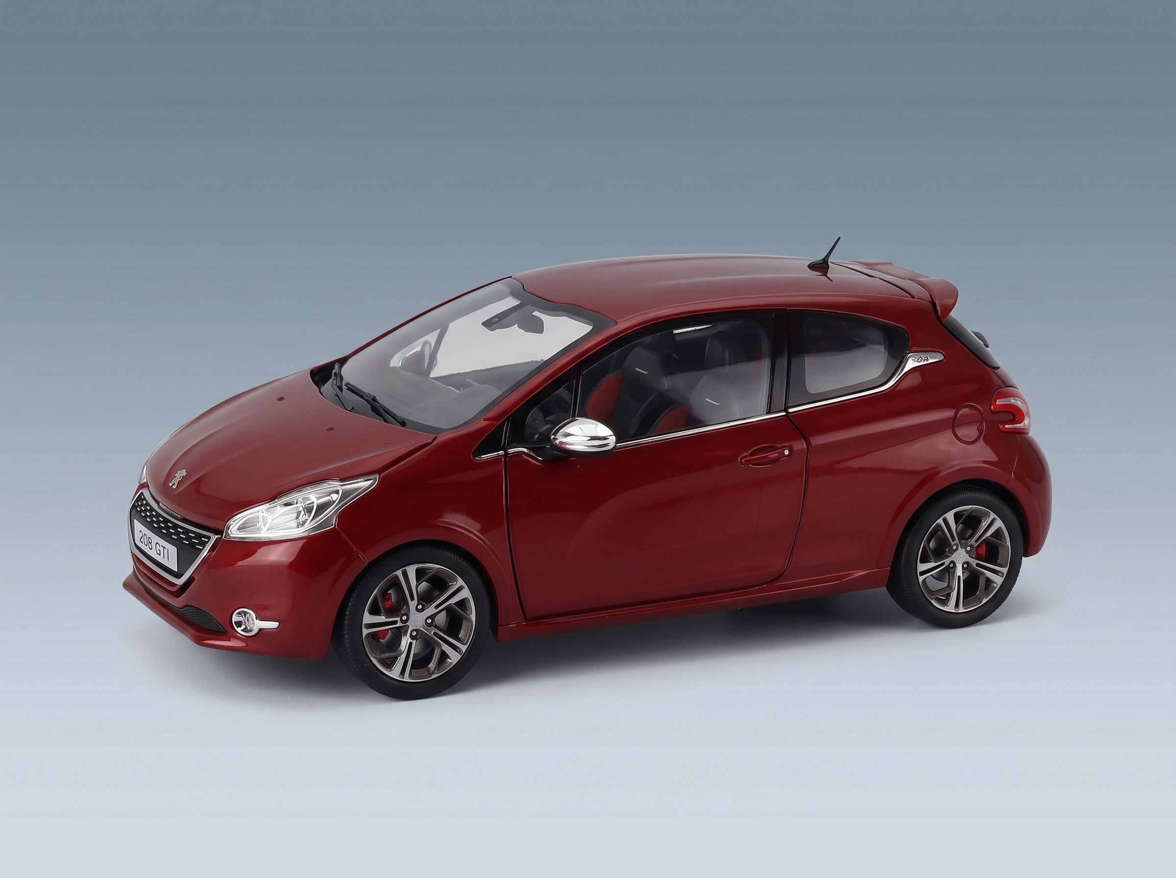 Peugeot 208 GTI 2013 Rubis Red Metallic Norev 1:18 scale model - front three-quarter view