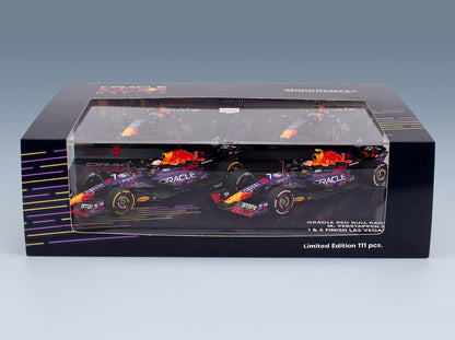 Red Bull RB19 Set 2x Oracle Red Bull Racing No. 1 Max Verstappen World Champion Winner Las Vegas USA GP + No. 11 3rd Las Vegas USA GP Sergio Perez 2023 Minichamps 1:43 scale model - side view in display case