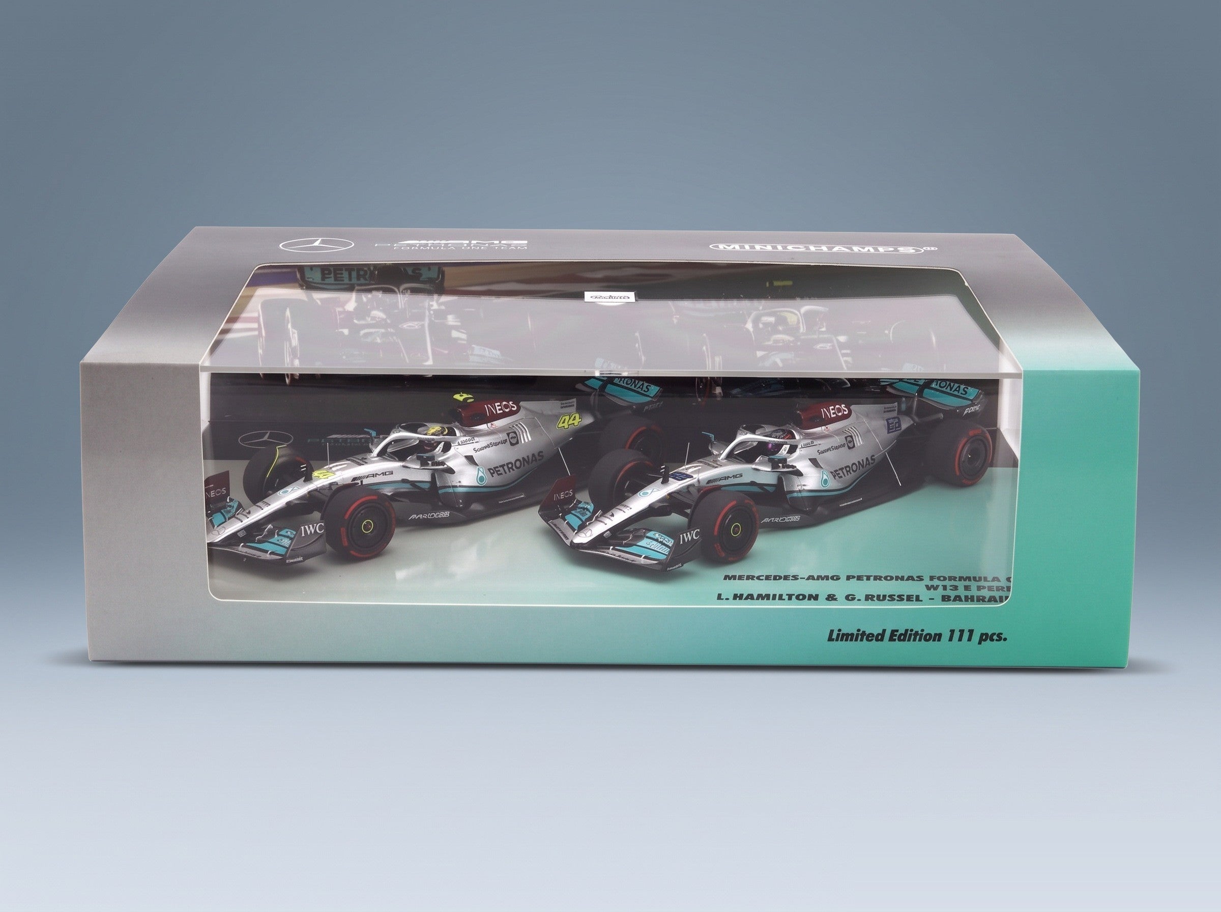 Mercedes W13E Set 2x Mercedes-AMG Petronas F1 No. 44 3rd Bahrain GP Lewis Hamilton No. 63 4th Bahrain GP George Russell 2022 Minichamps 1:43 scale model - side view in display case