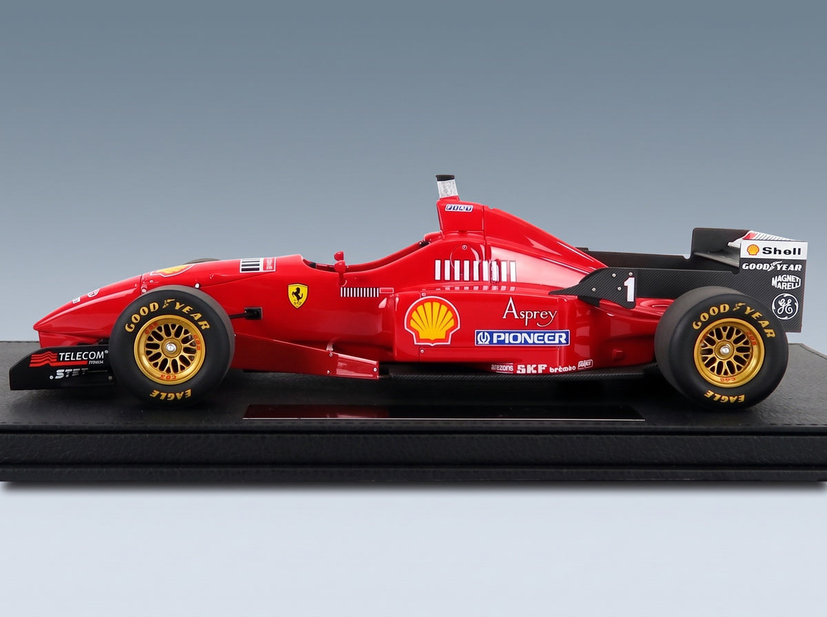 Ferrari F310 No. 1 Michael Schumacher Season 1996 with Showcase GP Replicas 1:18 scale model - front three-quarter view on display base