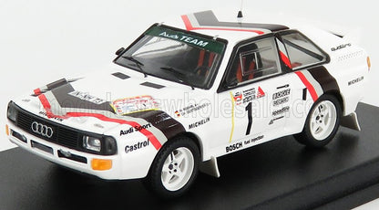 White Audi Sport rally car model with black and red racing stripes, white wheels, and sponsor logos, offered on Vroomi