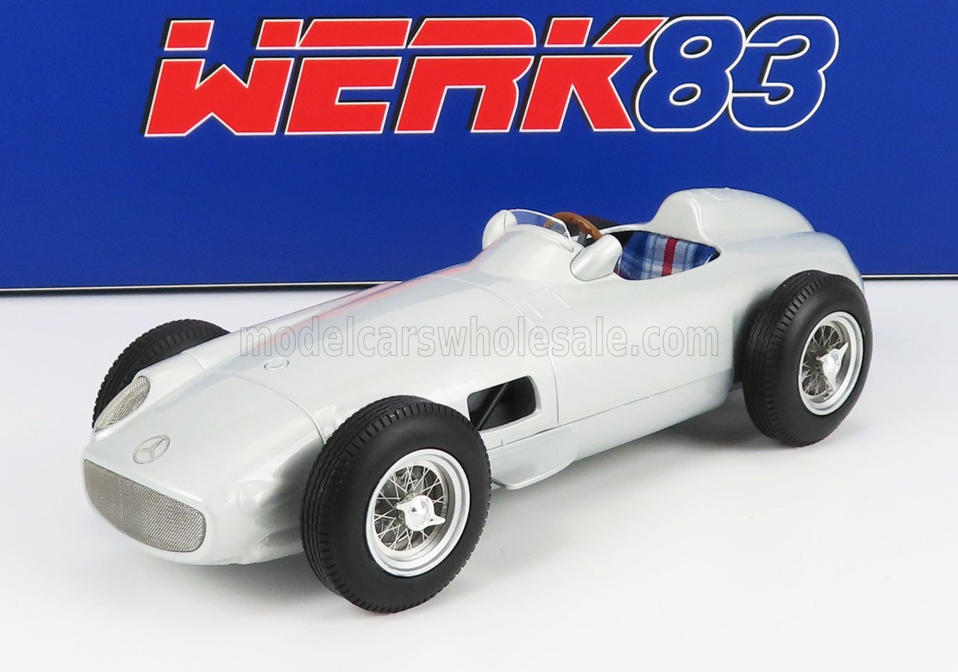 Silver classic Mercedes race car model with wire wheels, plaid seat, and WERK83 logo, available on Vroomi