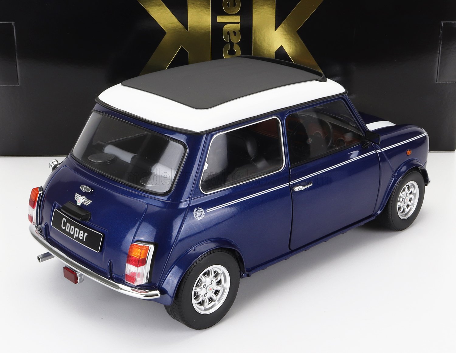 Blue Mini Cooper model car with white roof and detailed features, available on Vroomi platform