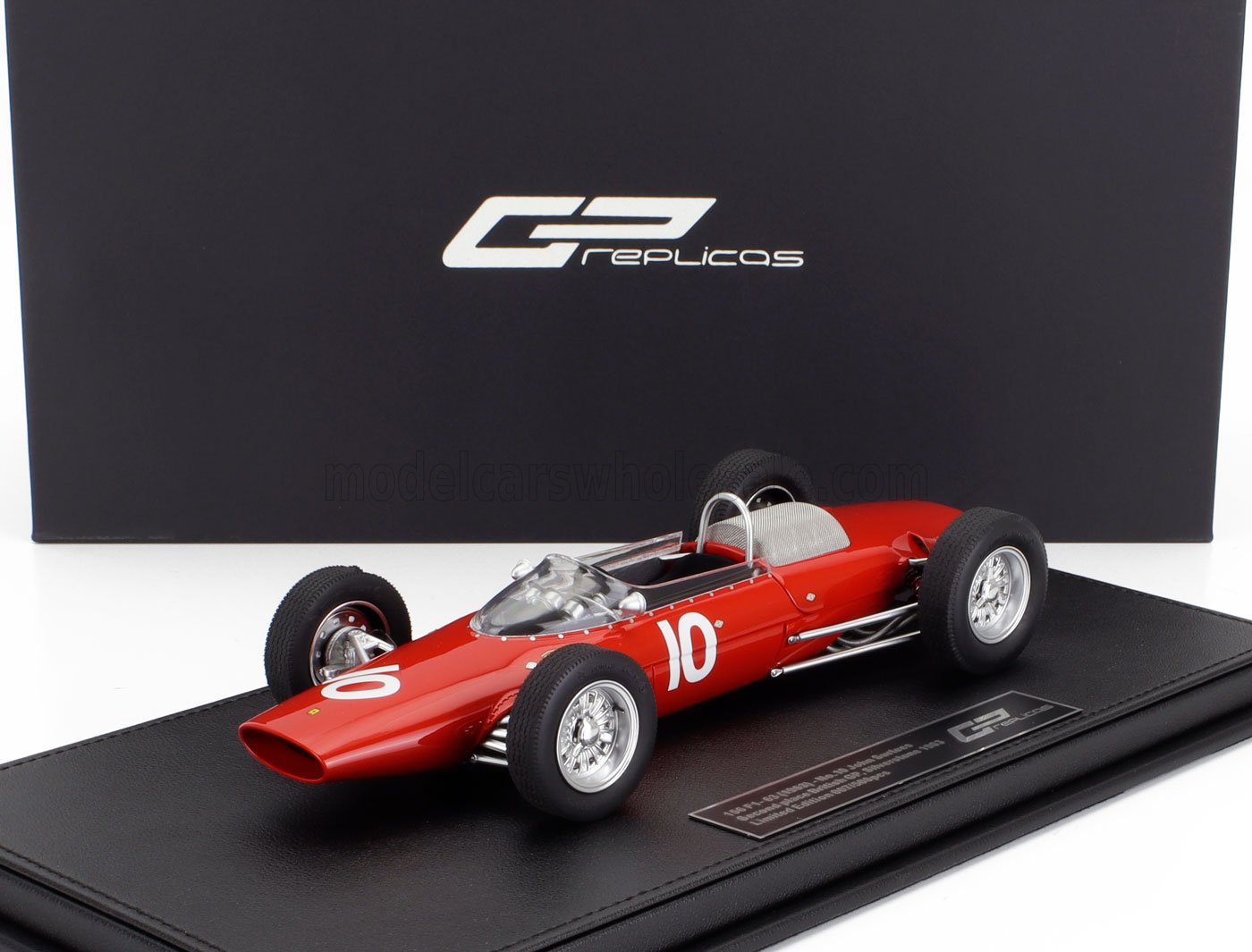 Red vintage race car model with number 10 on black display base, offered through Vroomi