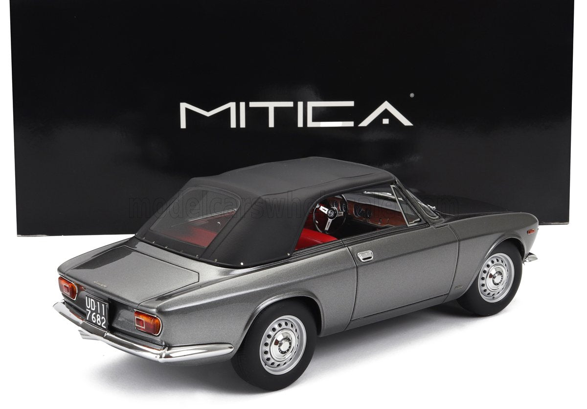 Coche clásico gris con capota blanda negra e interior rojo, con la marca MITICA, a la venta en Vroomi.