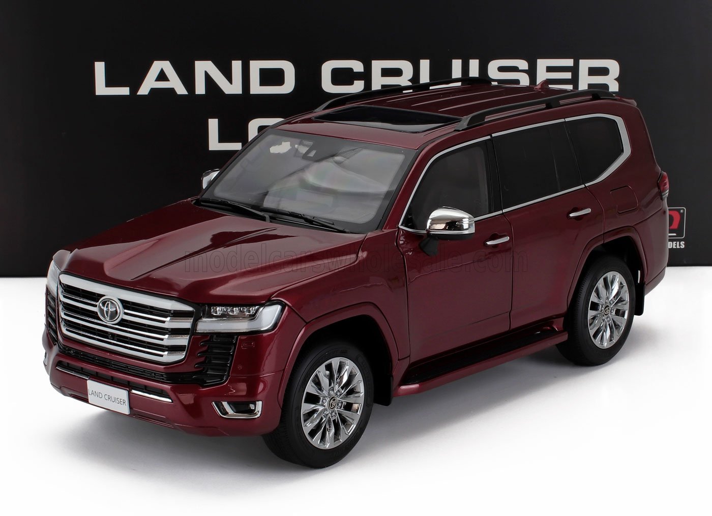 Maroon Toyota Land Cruiser SUV model with chrome details and sunroof, available on Vroomi