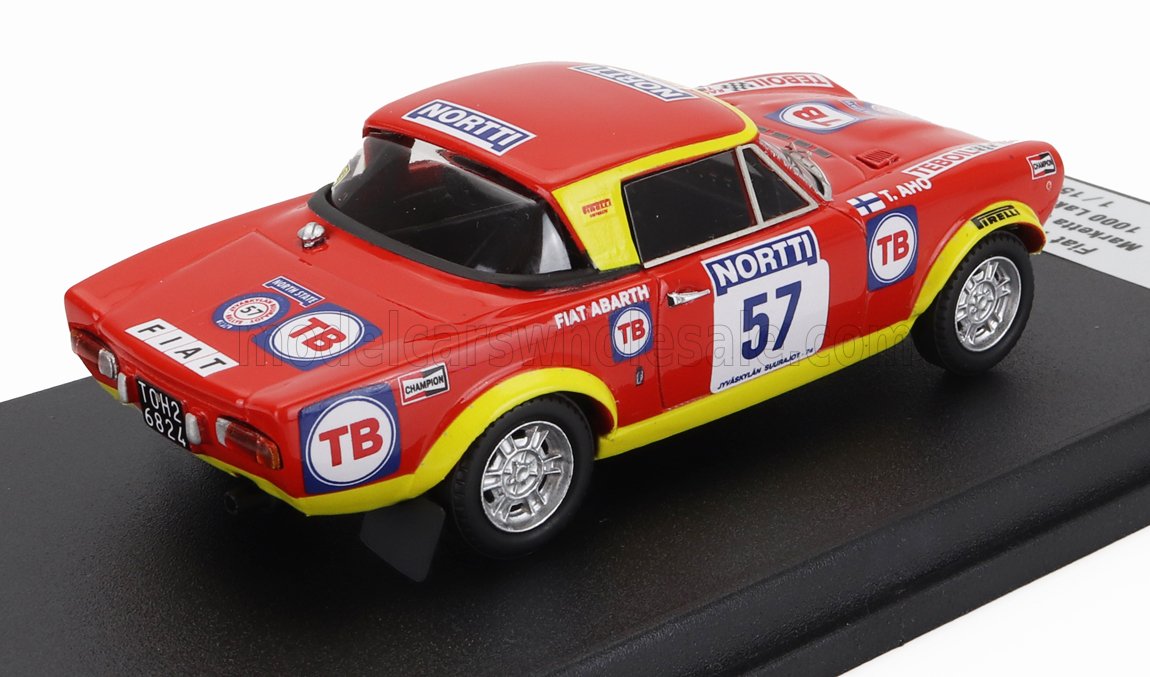Modelo vintage de coche de rally Fiat Abarth rojo y amarillo con adhesivos de carreras expuesto en un soporte negro, disponible en Vroomi.