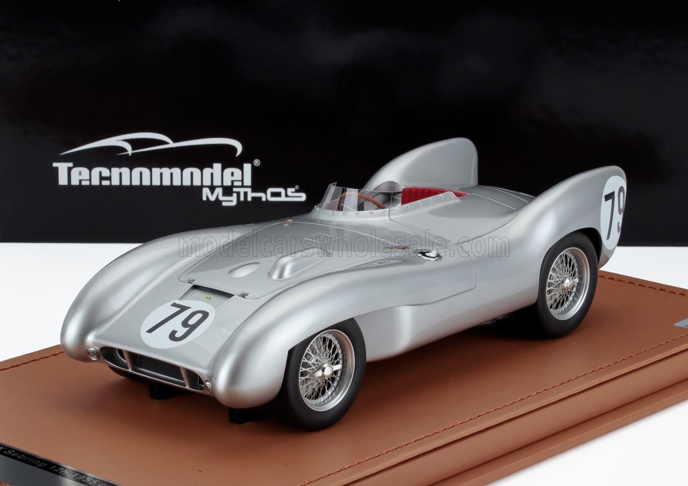 Silver vintage Tecnomodel racing car model with number 79 on a brown base, available via Vroomi