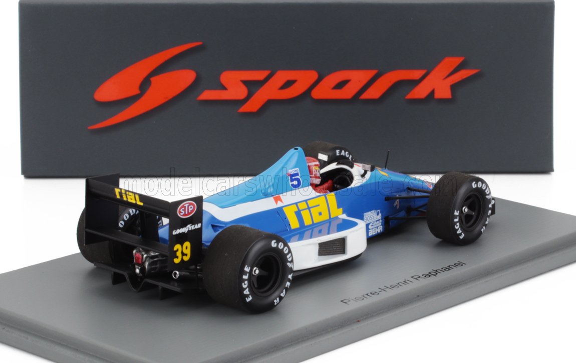 Coche de carreras Rial F1 a escala 1:43, azul y blanco, con logotipos de STP y Goodyear, Pierre-Henri Raphanel, disponible en Vroomi.