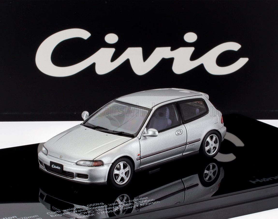 Silver Honda Civic model car on black display with Civic logo, available on Vroomi platform
