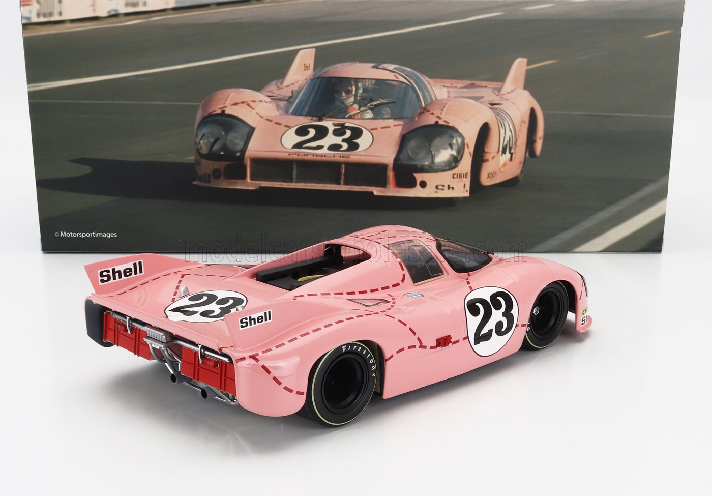 Pink Porsche 917 race car model with number 23 and Shell logos, featured with vintage racing photo, now on Vroomi