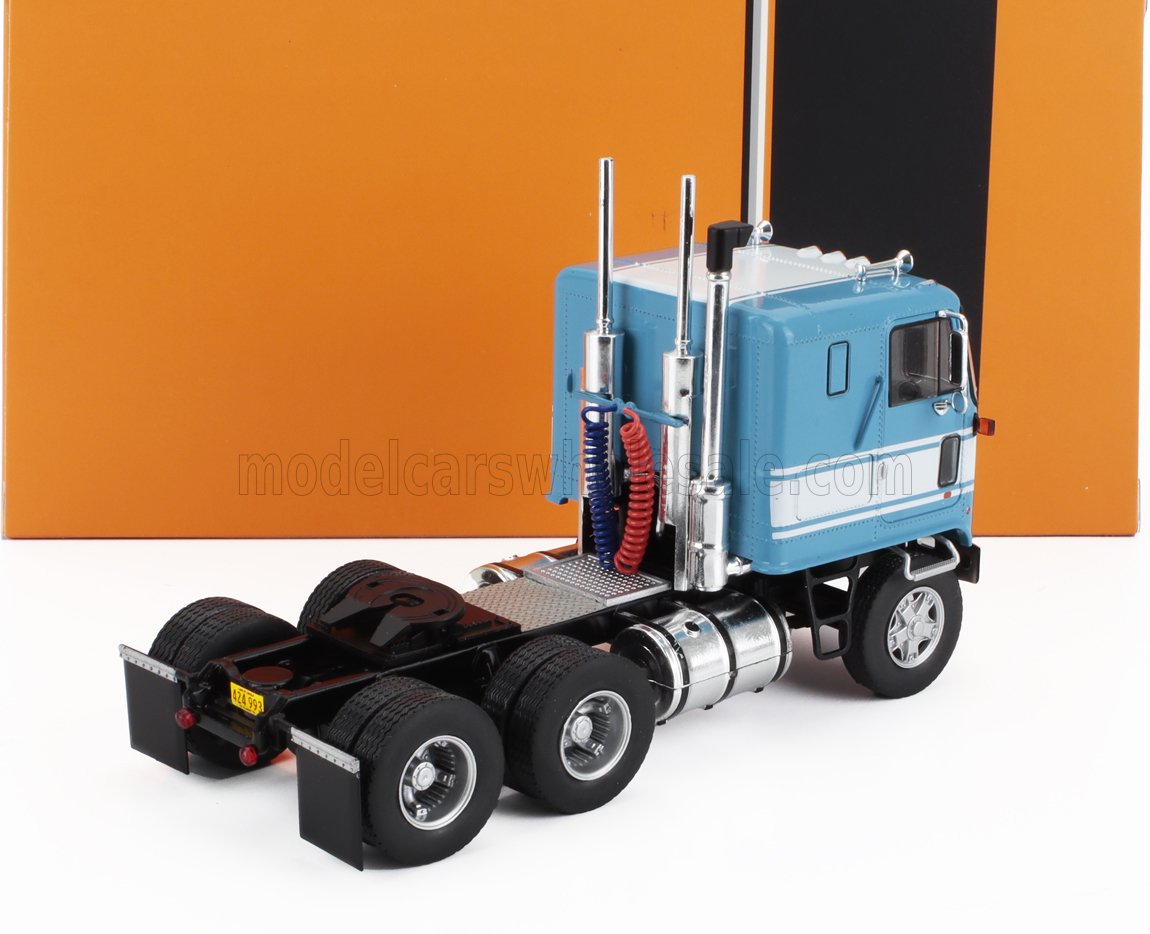 Detailed blue and white semi truck model with dual exhausts and black chassis, available on Vroomi
