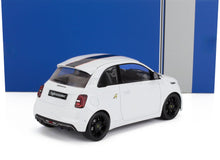 Maqueta de coche Abarth 500 blanco con rayas negras de carreras y ruedas negras, expuesta sobre un fondo azul y gris, disponible en Vroomi.
