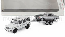 MERCEDES BENZ - CLASE G (W463) 2018 CON REMOLQUE + CLASE SL 450SLC 5.0 COUPÉ (C107) 1980 - BLANCO PLATEADO NEGRO - Vroomi