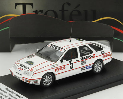 White Ford Sierra XR 4x4 rally car model with Texaco and Pirelli logos, available on Vroomi