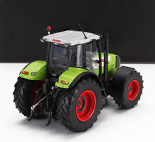 Maqueta detallada del tractor Claas Ares 847 con carrocería verde, llantas rojas y techo blanco disponible en Vroomi.