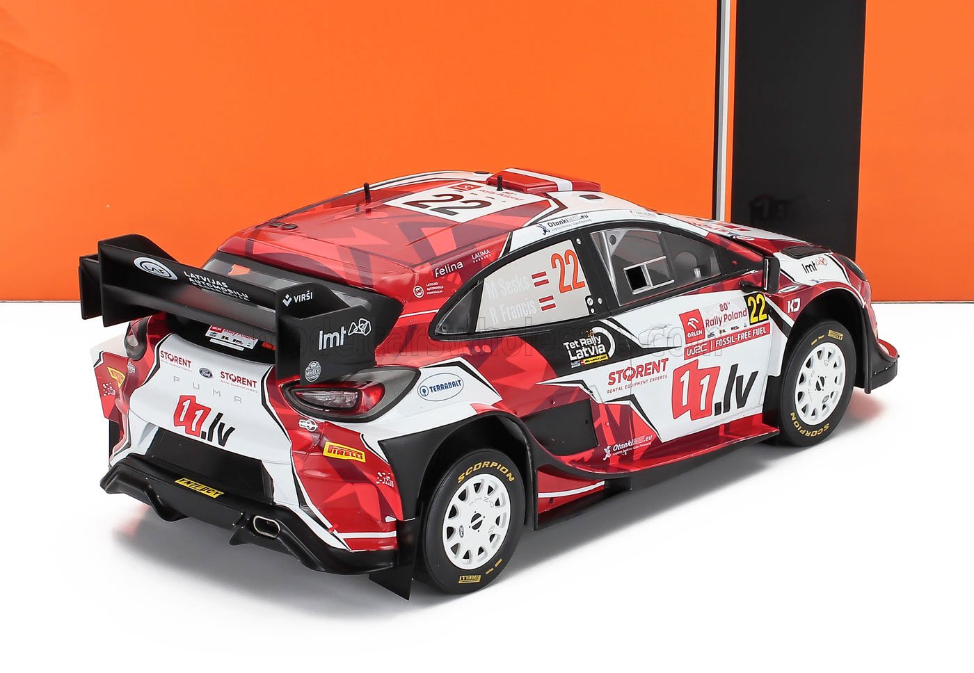 Modelo de coche de rally rojo y blanco con adhesivos de carreras, ya disponible en Vroomi.