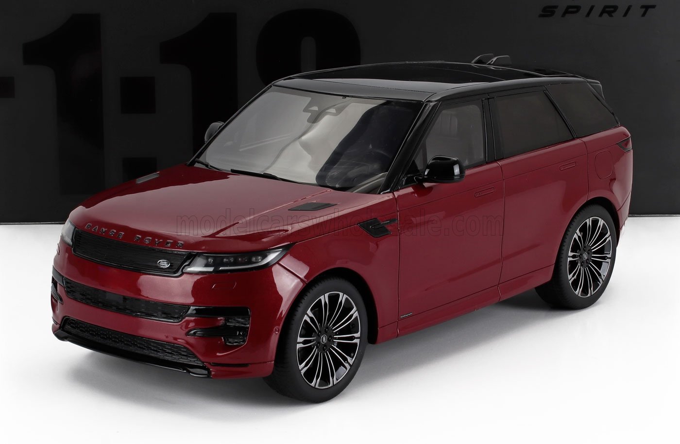 Red and black Range Rover SUV die-cast scale model on white surface, detailed 1:18 replica available at Vroomi