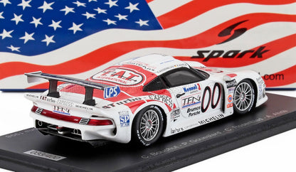 Detailed white and red Brumos Porsche 911 GT1 race car model with number 00, on display with American flag backdrop, offered on Vroomi