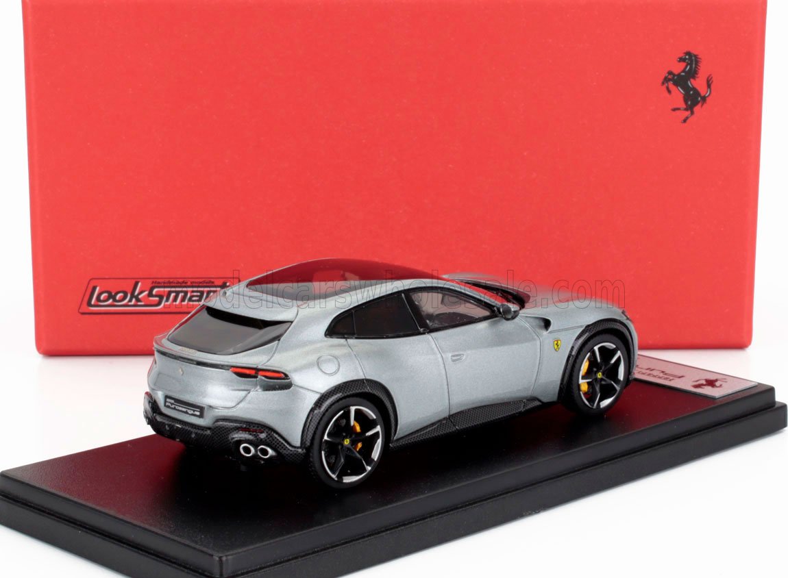 Silver Ferrari Purosangue model car on display stand with red Ferrari box, available via Vroomi