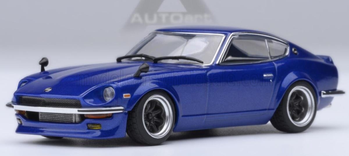 Blue classic Nissan 240Z model car with wide tires, shown in studio lighting, available through Vroomi