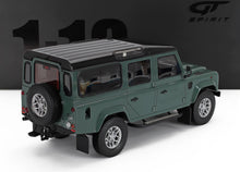 Die-cast 1:18 scale Land Rover Defender model in green with black roof, detailed wheels, and spare tire, available at Vroomi