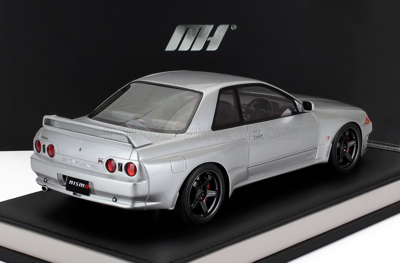 Silver Nissan Skyline GT-R R32 model car on display stand, now accessible on Vroomi