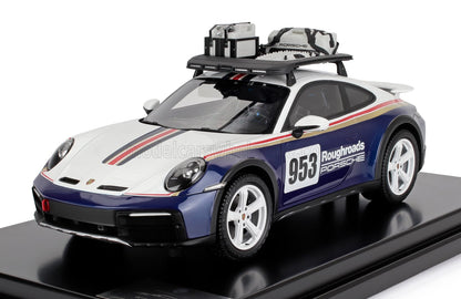 Modelo de coche de rally Porsche 953 Roughroads con carrocería blanca y azul, portaequipajes con equipamiento, disponible en Vroomi.