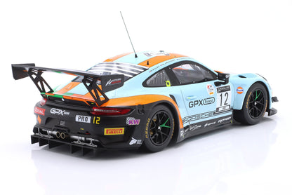 Rear view of light blue and orange Porsche race car with number 12, Pirelli tires, and detailed spoiler, available on Vroomi