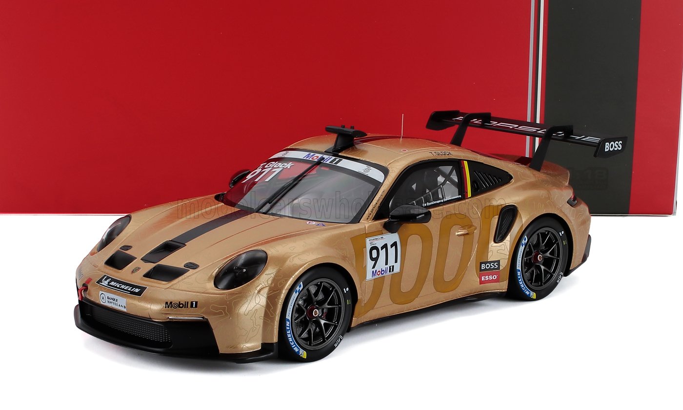 Gold Porsche 911 race car scale model with black rear wing, available for collectors now.