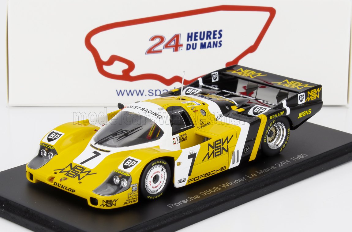 Model of yellow and black Porsche 956B race car, 1985 Le Mans winner, featured with 24 Heures du Mans backdrop and available on Vroomi
