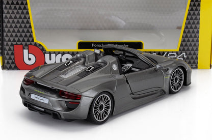 Maqueta de coche Porsche 918 Spyder gris fundido a presión con interior detallado y techo abierto, presentada en un embalaje de marca, disponible a través de Vroomi.