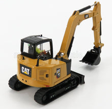 Mini-pelle CAT 308 jaune avec chenilles noires et figurine d'opérateur, disponible chez Vroomi.