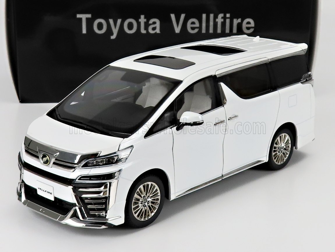 Modèle réduit de Toyota Vellfire blanche avec toit ouvrant, présenté sur un socle blanc, disponible à l'achat sur Vroomi.