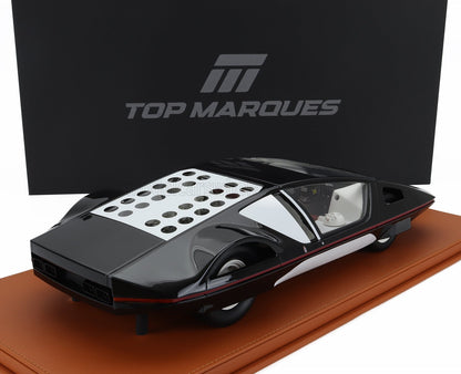 Modèle réduit futuriste noir et blanc avec aérations circulaires sur le toit, sur socle en cuir, proposé sur Vroomi.