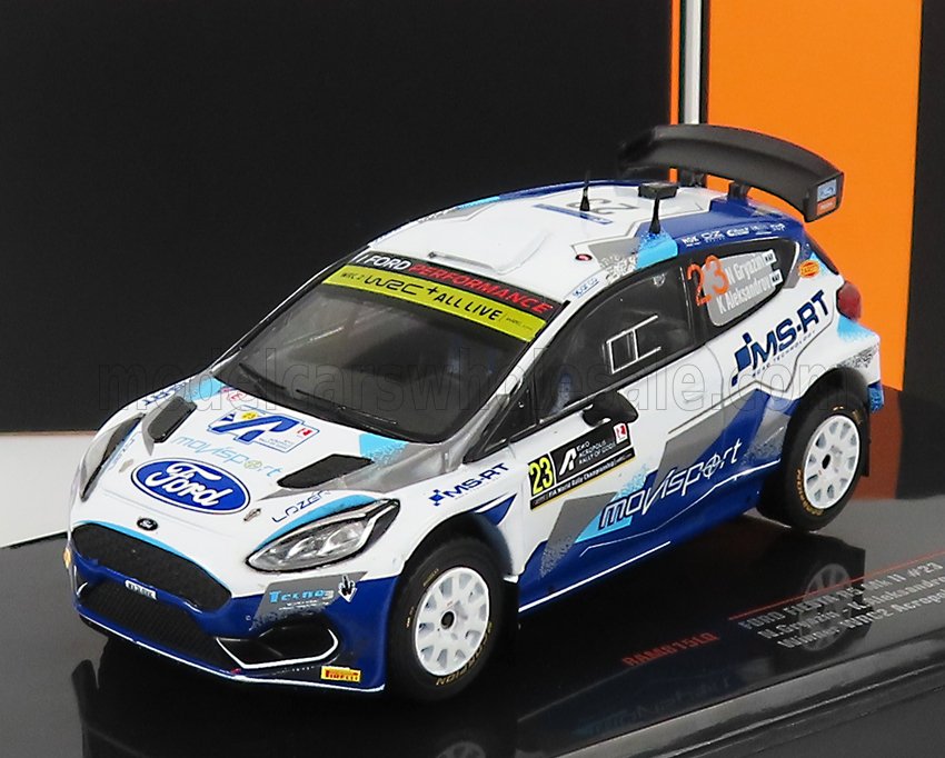 Modèle réduit de voiture de rallye Ford blanche et bleue avec logo M-Sport, décalcomanies détaillées et aileron arrière, proposé sur Vroomi.
