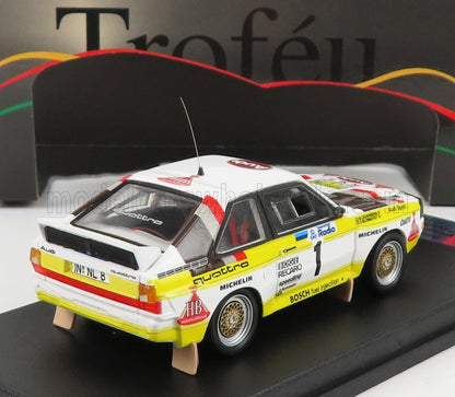 Modèle réduit de voiture de rallye Audi Quattro blanche et jaune avec décalcomanies de course, présenté sur Vroomi.