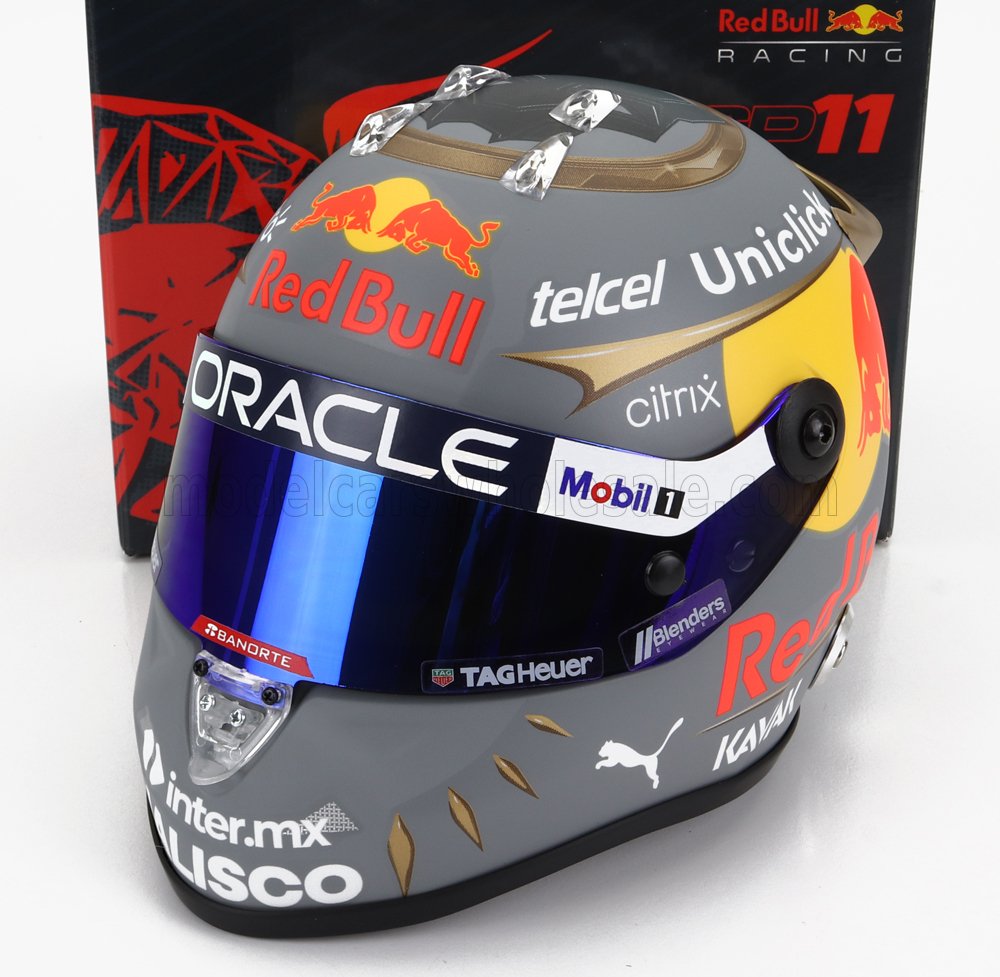 Casque de Formule 1 Red Bull gris et jaune avec visière bleue et logos des sponsors, présenté sur Vroomi.