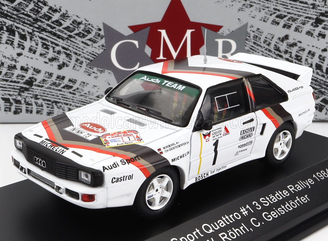 White Audi Sport Quattro rally car model with red and black stripes, detailed decals, showcased with CMR branding, available via Vroomi